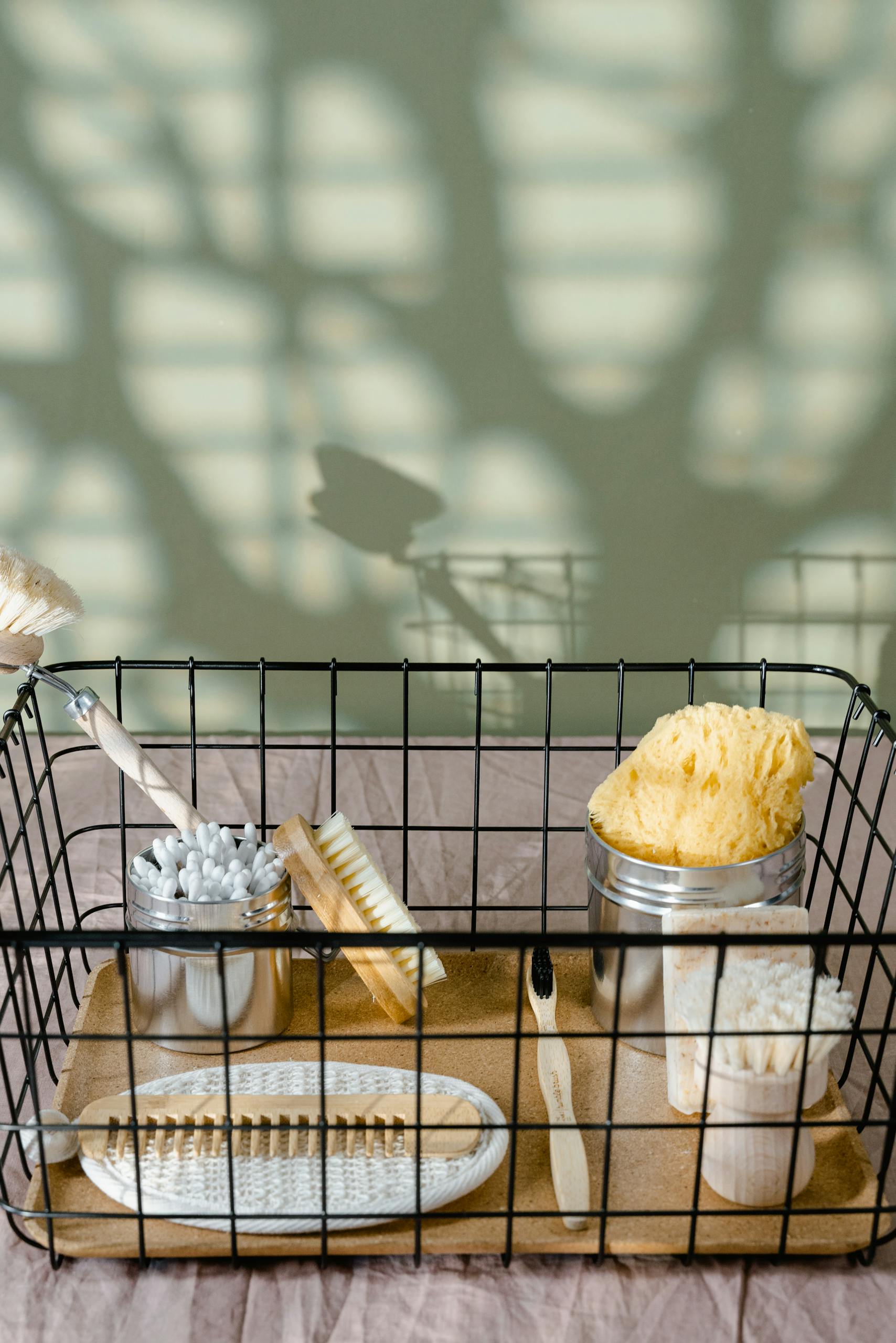 Eco-friendly bathroom essentials in a metal basket for a zero waste lifestyle.