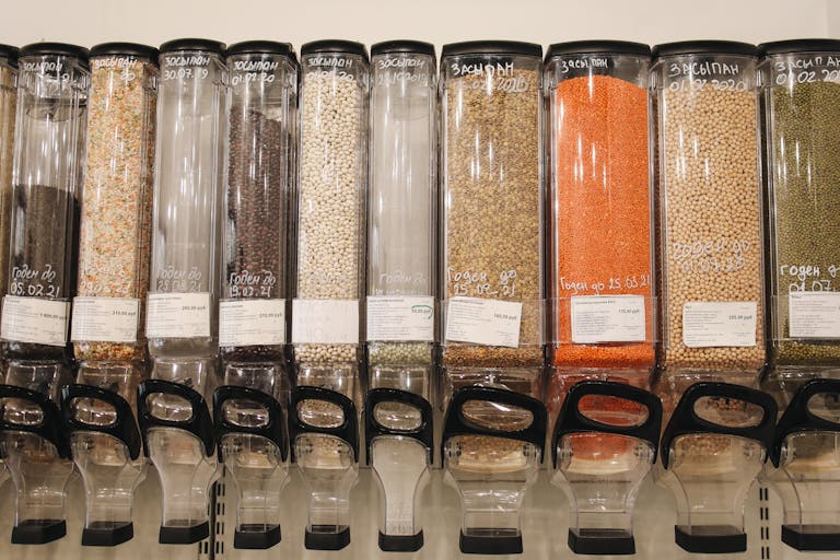 Row of eco-friendly bulk food dispensers in a shop promoting zero waste shopping.