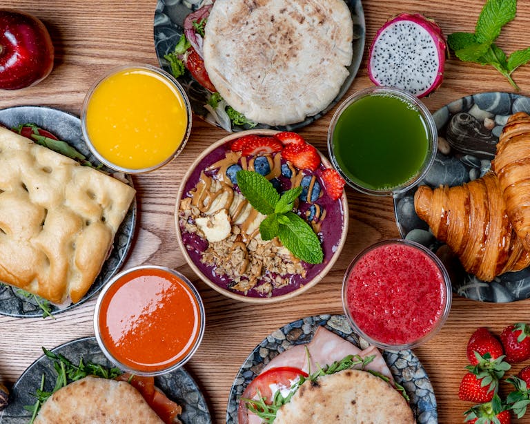 Vibrant breakfast spread featuring smoothies, pastries, and fresh fruits. Perfect for a healthy start.