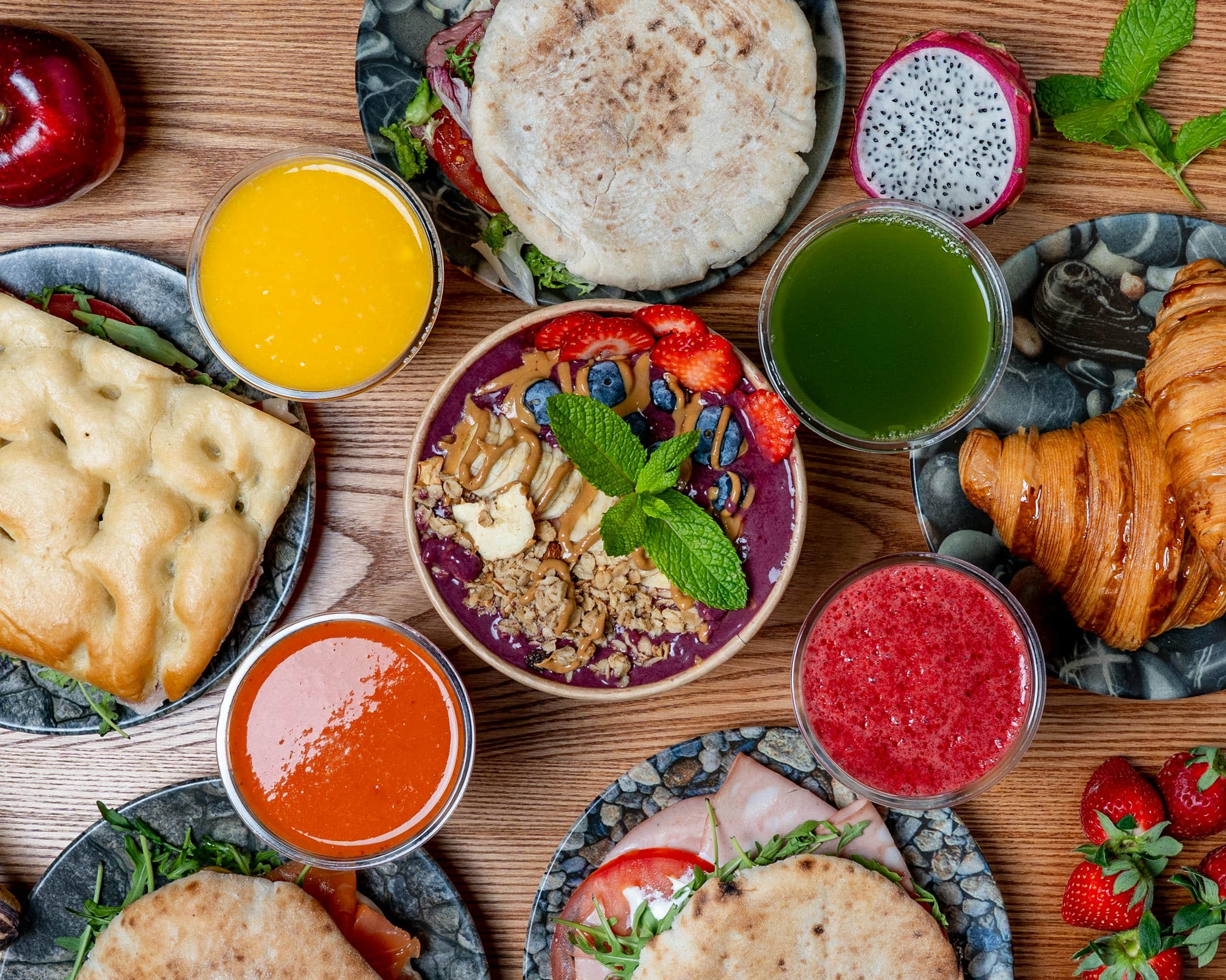 Vibrant breakfast spread featuring smoothies, pastries, and fresh fruits. Perfect for a healthy start.